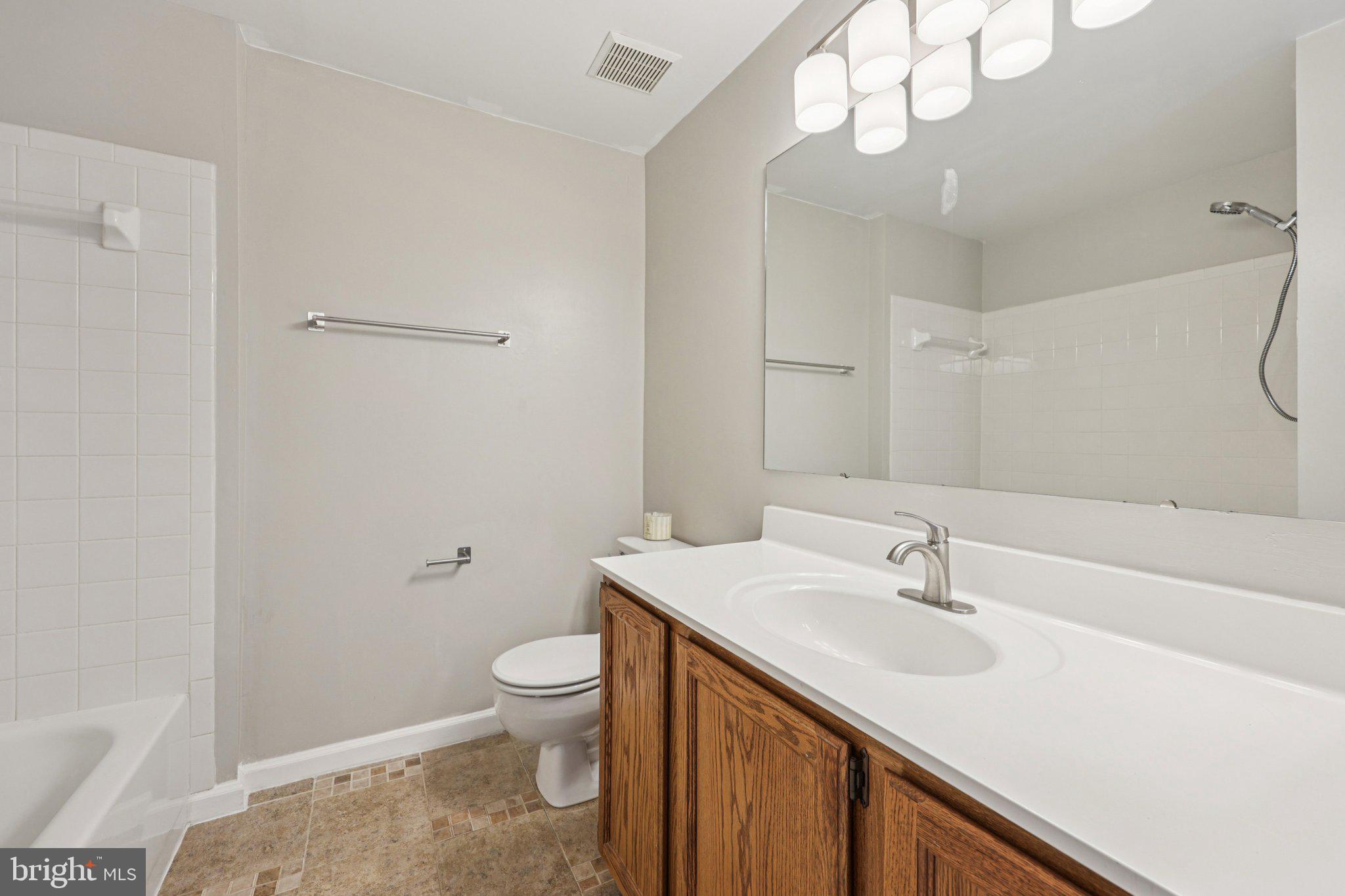 43494 Postrail Square Ashburn, VA 20147 - Photo 25 of 38 a bathroom with a sink a toilet and a mirror