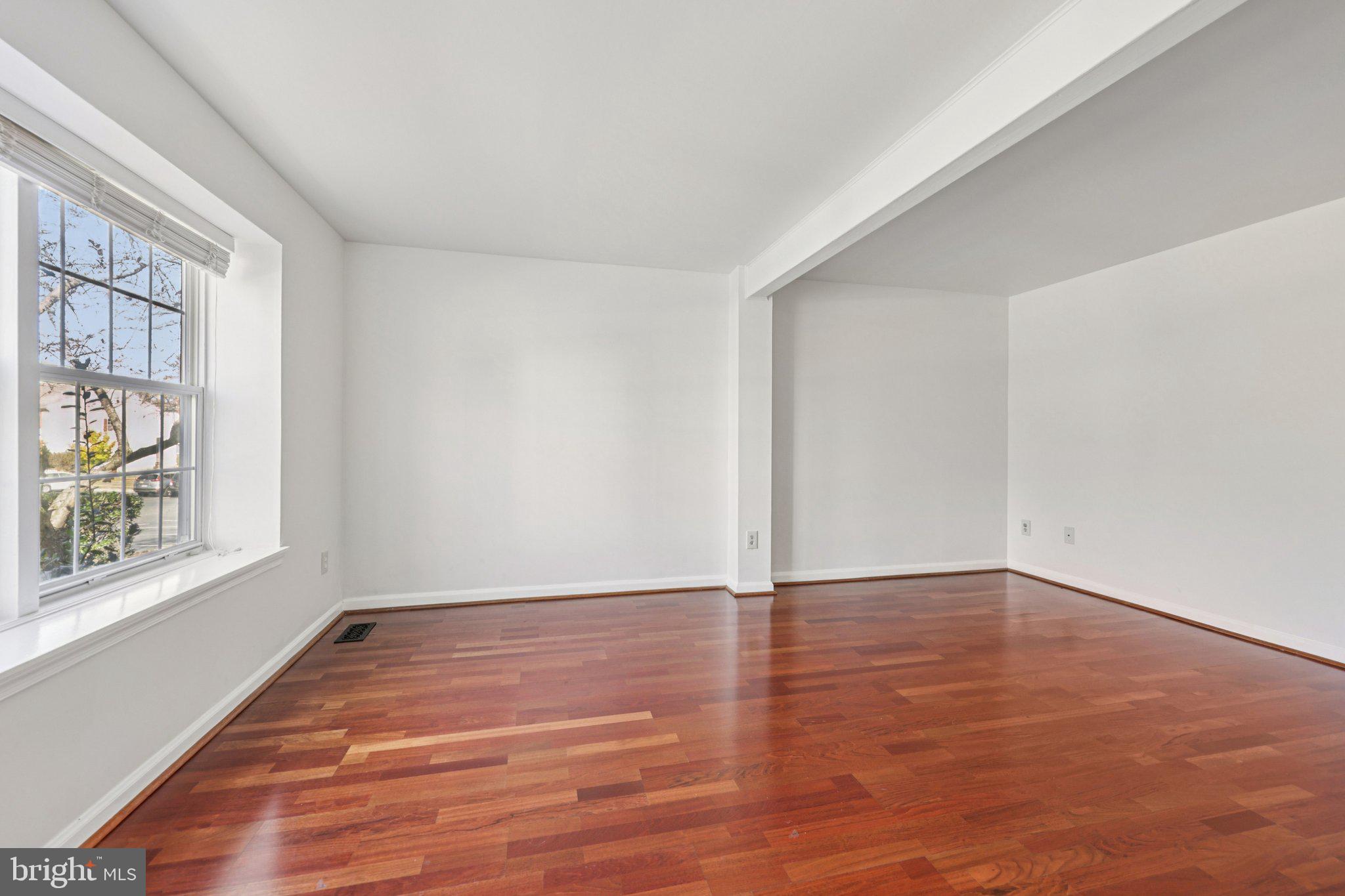43494 Postrail Square Ashburn, VA 20147 - Photo 3 of 38 a view of an empty room with wooden floor and a window