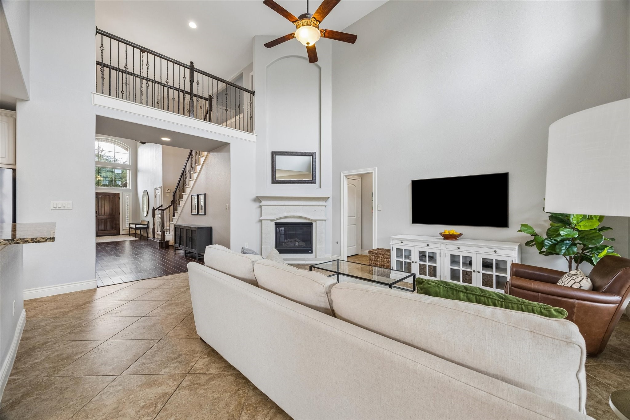 1616 Hewitt Drive Houston, TX 77018 - Photo 7 of 44 Open sightlines from the living room highlight the dramatic ceiling height and second floor overlook, reinforcing the home’s spacious and connected layout.