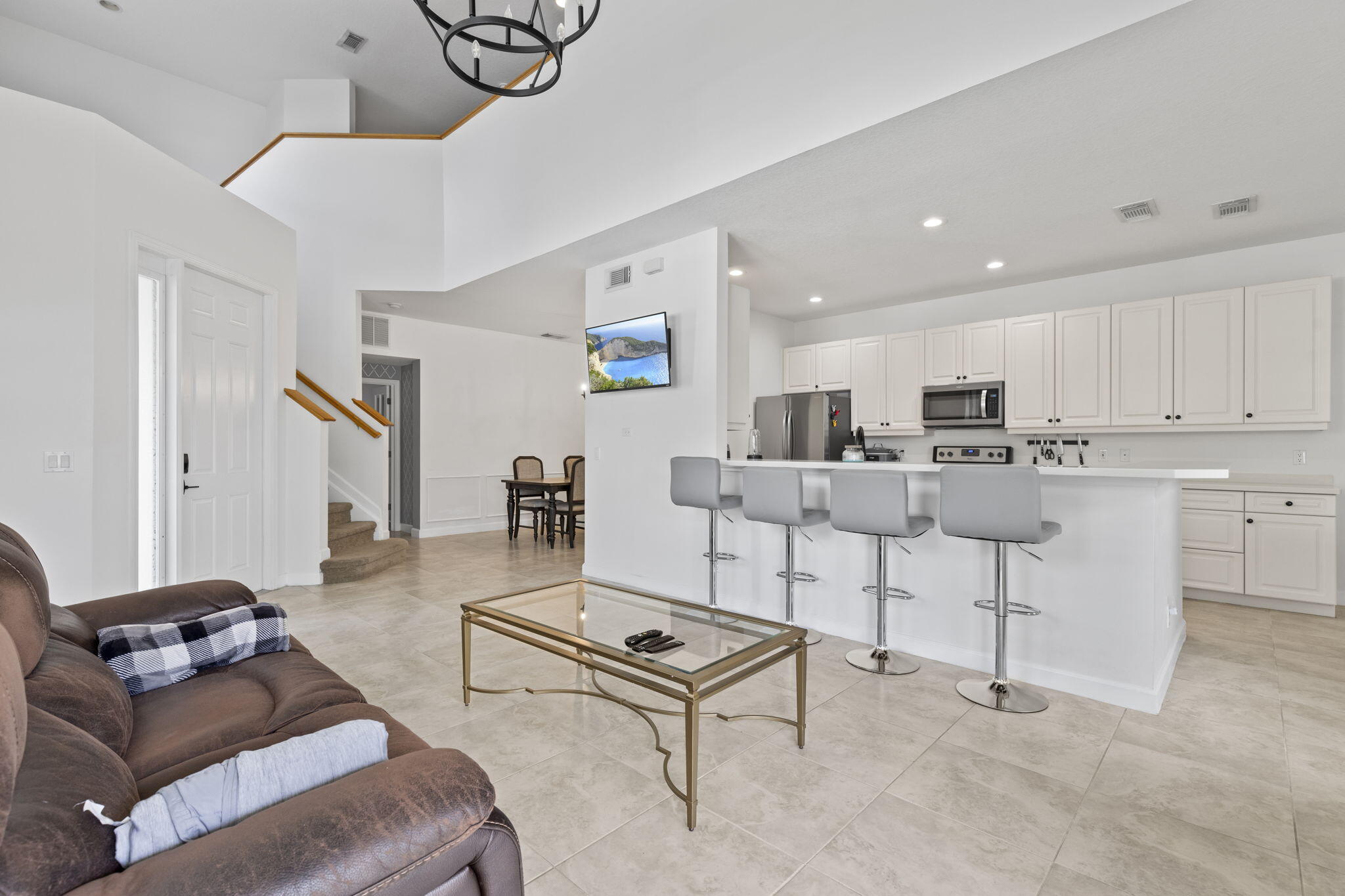 a living room with furniture and kitchen view