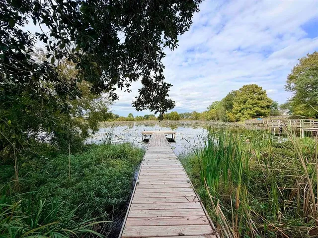 a view of a pathway both side of building with yard