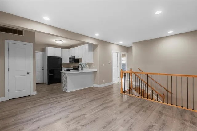 a view of a kitchen with a sink and stainless steel appliances