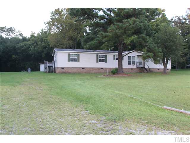 1553 Lettuce Hall Road Spring Hope, NC 27882 - Photo 1 of 16 a front view of a house with a garden and yard