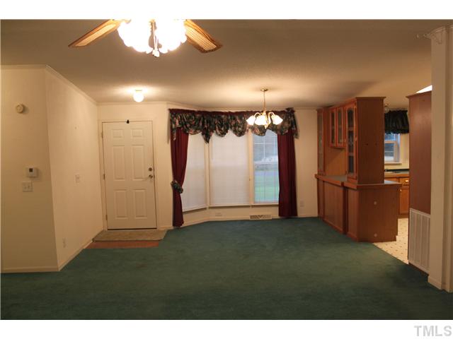 1553 Lettuce Hall Road Spring Hope, NC 27882 - Photo 3 of 16 a view of a refrigerator in kitchen and an empty room