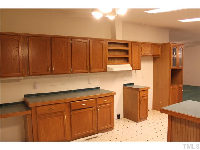 1553 Lettuce Hall Road Spring Hope, NC 27882 - Photo 6 of 16 a kitchen with stainless steel appliances granite countertop a refrigerator and cabinets