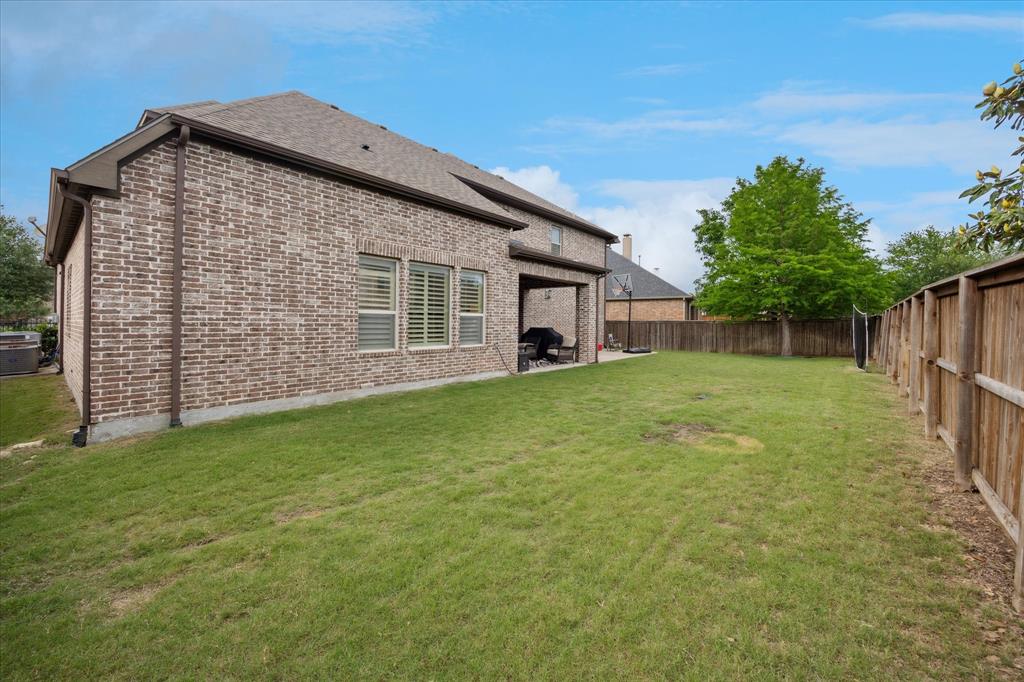 580 Butchart Drive Prosper, TX 75078 - Photo 33 of 40 Back of house with brick siding, a patio, central AC, and a shingled roof