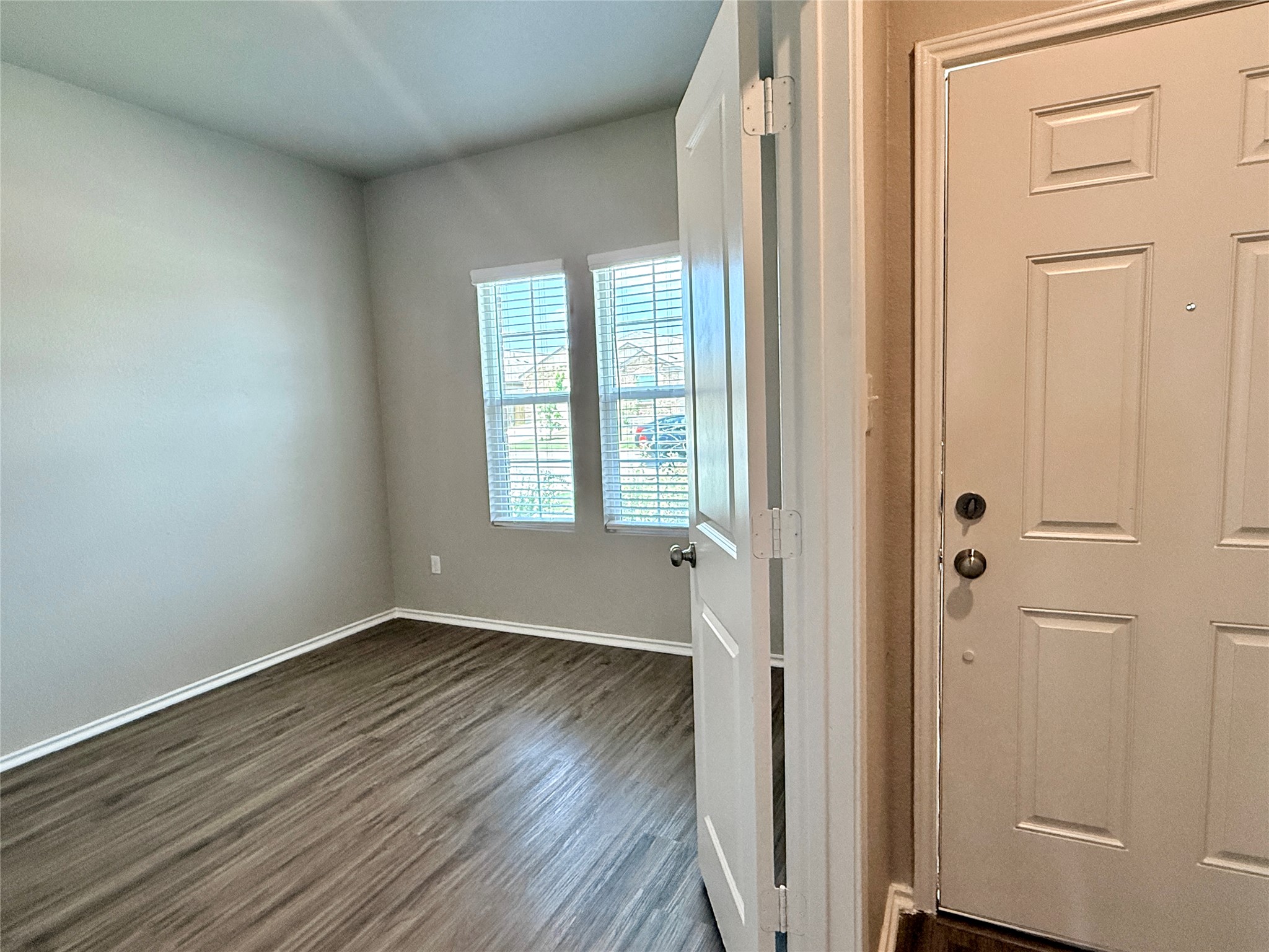 129 Perfect World Loop Jarrell, TX 76537 - Photo 4 of 31 Hardwood-style flooring extends from the welcoming entry into an adaptable, well-lit flex space.
