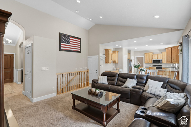 1447 Meadow Lane Mapleton, UT 84664 - Photo 10 of 67 Vaulted ceiling, recessed lighting, wood-finish railing, archway entry, and a kitchen with wood-finish cabinetry