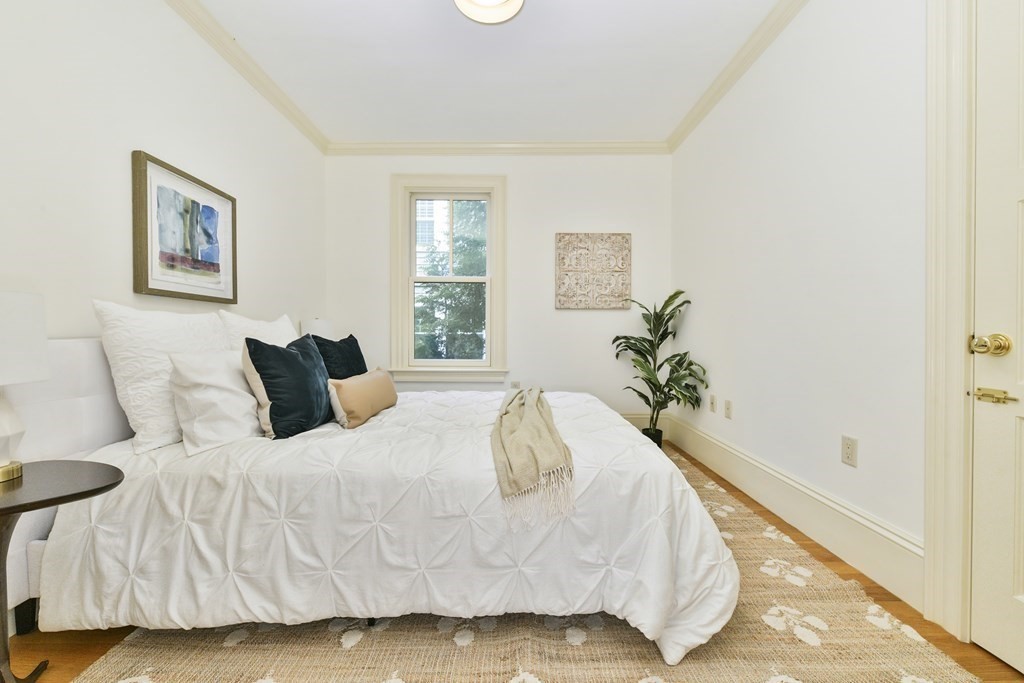 35 Blakeslee Street Cambridge, MA 02138 - Photo 12 of 31 a white bed sitting in a bedroom next to a window
