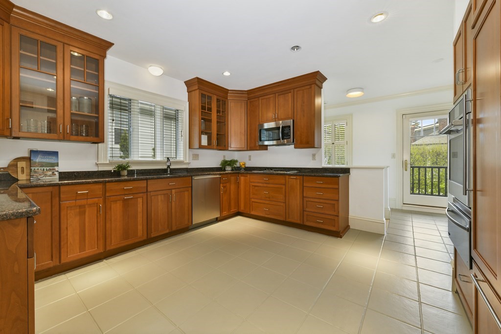35 Blakeslee Street Cambridge, MA 02138 - Photo 17 of 31 a large kitchen with stainless steel appliances granite countertop a sink and cabinets