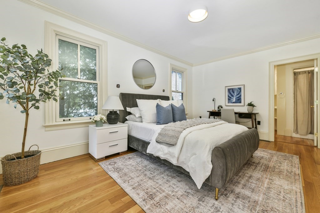 35 Blakeslee Street Cambridge, MA 02138 - Photo 8 of 31 a bedroom with a large bed and wooden floor