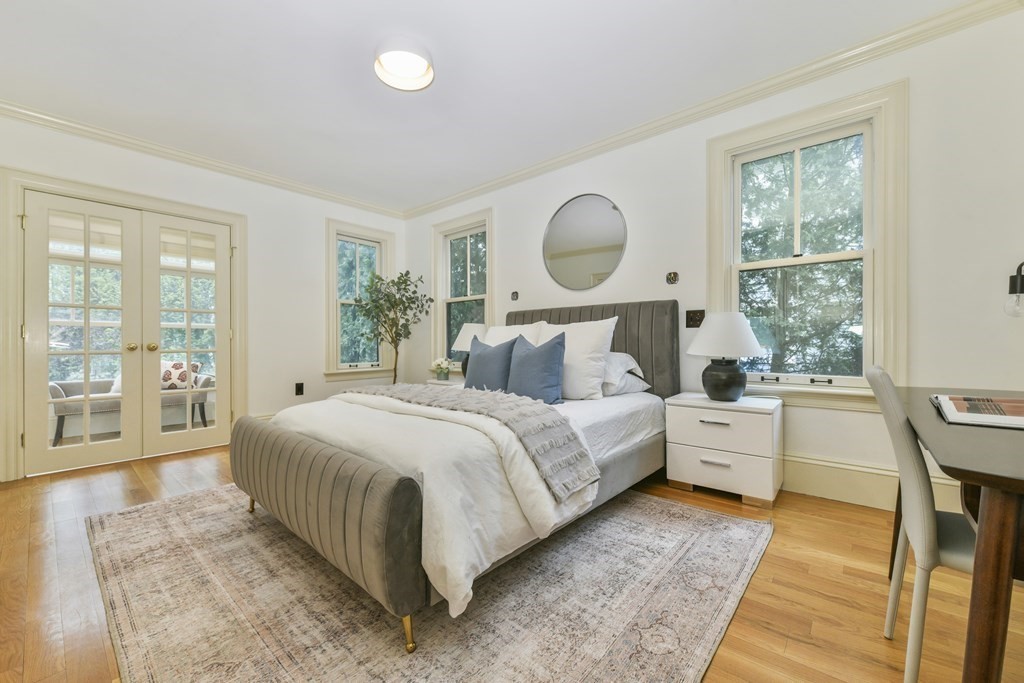 35 Blakeslee Street Cambridge, MA 02138 - Photo 9 of 31 a bedroom with a large bed and wooden floor