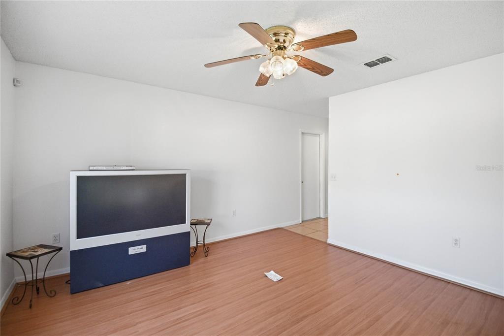 206 Taranto Way Kissimmee, FL 34758 - Photo 16 of 45 a view of room with wooden floor and ceiling fan