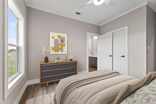 a bedroom with a bed and a window