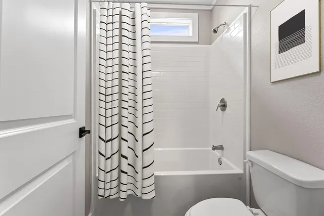 a bathroom with a bathtub and shower