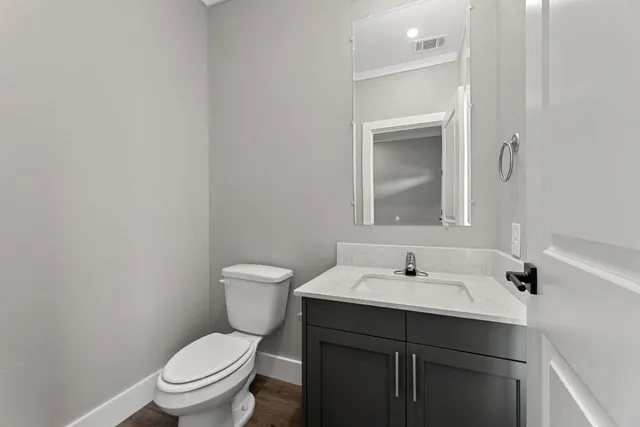 a bathroom with a sink toilet and vanity