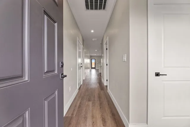 a view of hallway with wooden floor