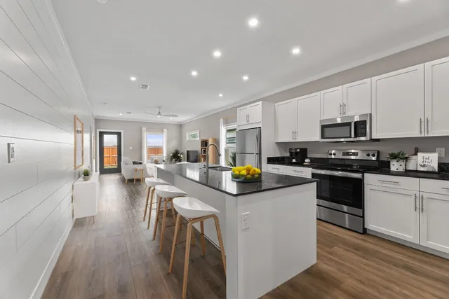 a kitchen with counter top space a sink appliances and cabinets