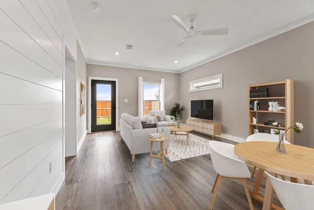 a living room with fireplace furniture and a wooden floor
