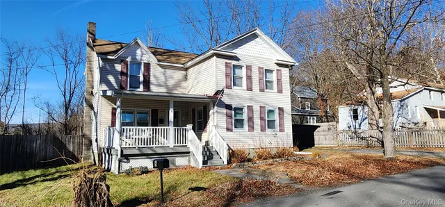 a view of a house with wooden fence