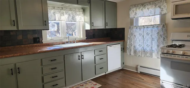 a kitchen with cabinets appliances and a window
