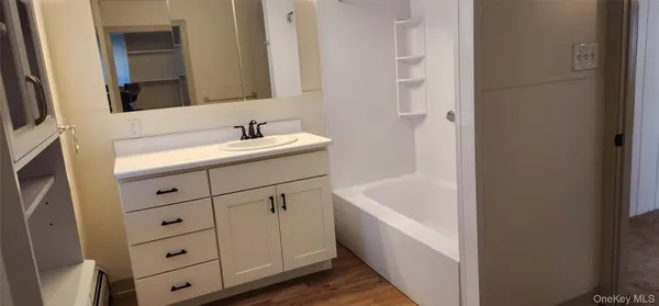 a bathroom with a bathtub and a sink