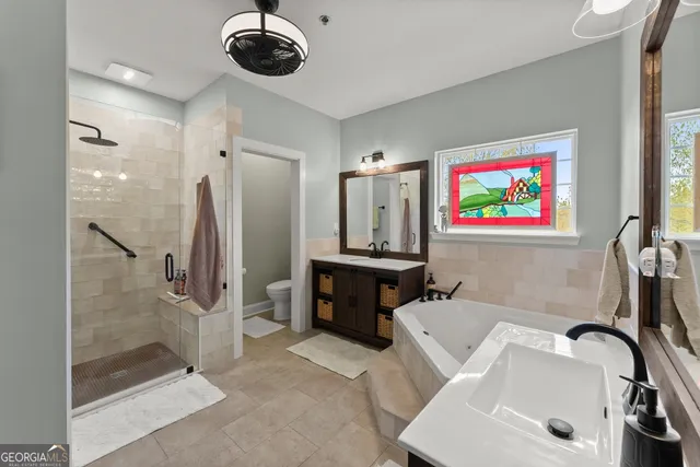 a view of a bathroom with a shower and mirror