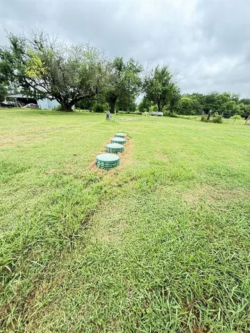 a view of a field with an trees
