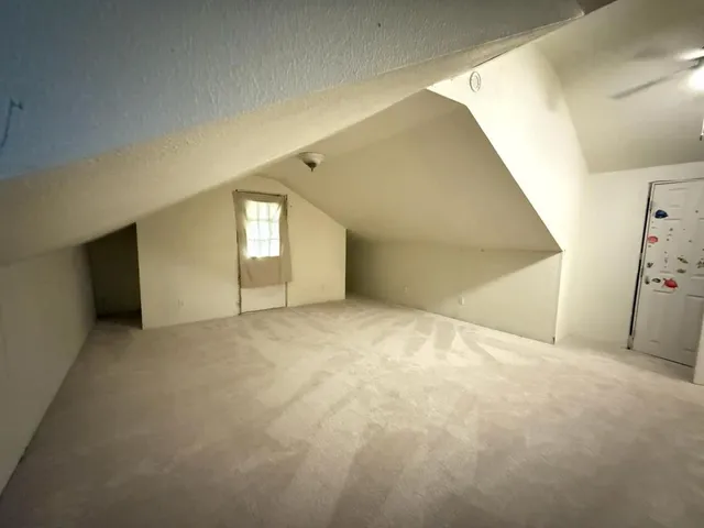 an empty room with a empty space and windows