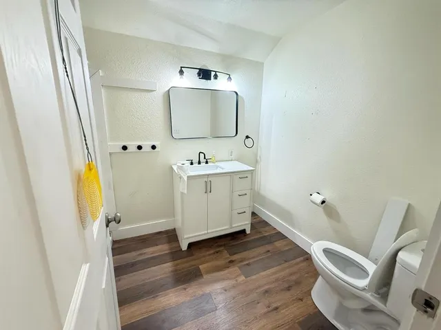 a view of a big house with a big yard and large trees