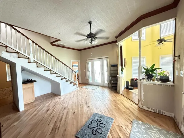 a very nice looking room with wooden floor and windows