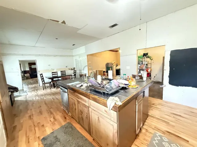 a kitchen with kitchen island a stove a sink and a refrigerator