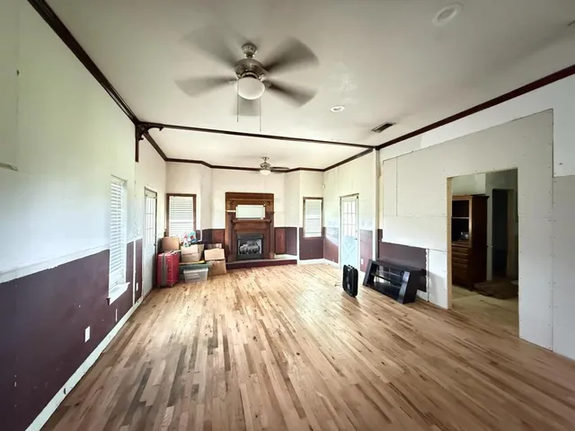 a view of living room kitchen with furniture and wooden floor