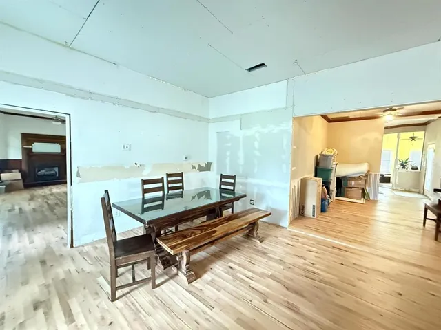 a living room with furniture a table and wooden floor