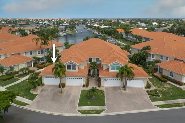 an aerial view of a house with a yard and lake view
