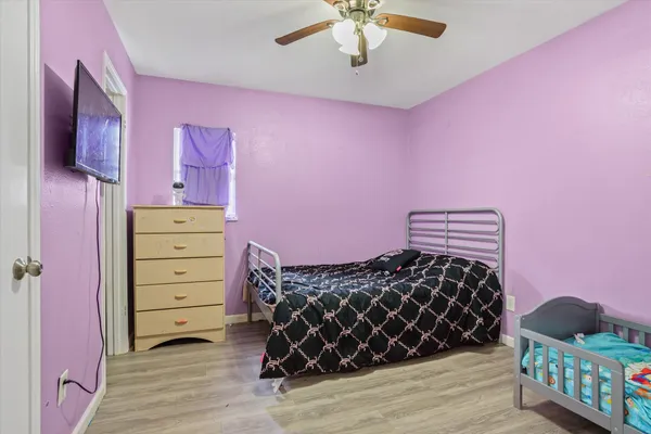 a bedroom with a bed and a chandelier