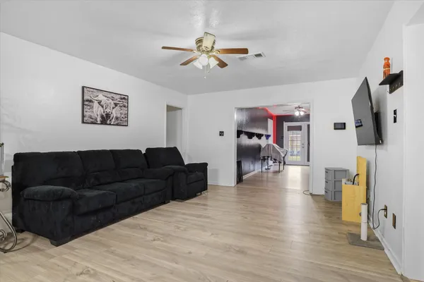 a living room with furniture and a chandelier