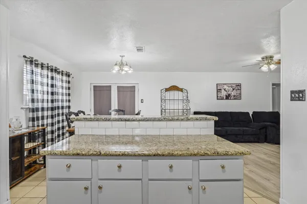 a kitchen with granite countertop a sink and a stove