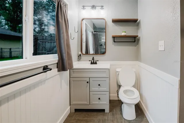 a bathroom with a toilet sink and mirror