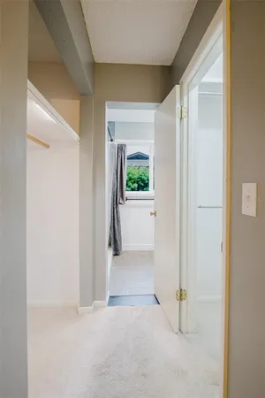 a view of a small space with wooden floor and a hallway