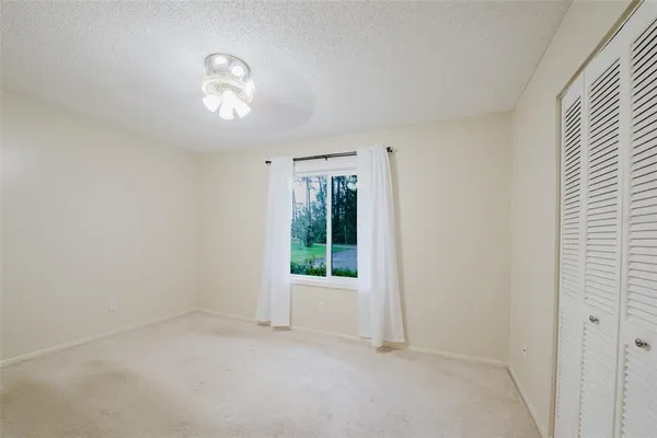 a view of a livingroom with wooden floor a fireplace and window