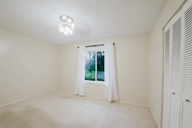 a view of a livingroom with wooden floor a fireplace and window