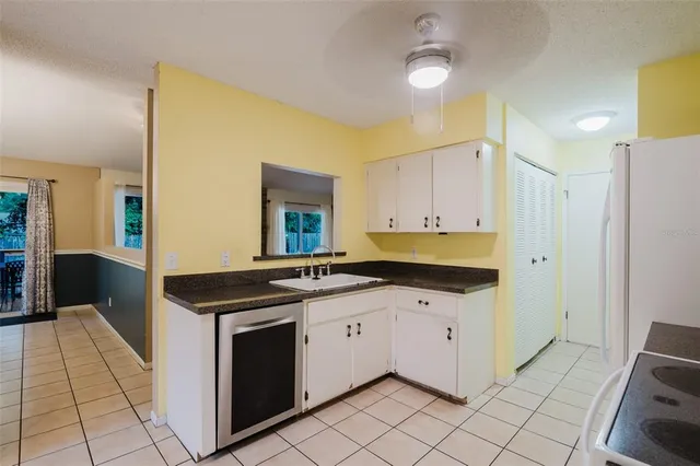 a kitchen with stainless steel appliances a stove a refrigerator and cabinets