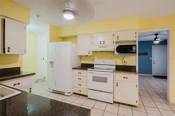 a kitchen with stainless steel appliances granite countertop a stove and a sink
