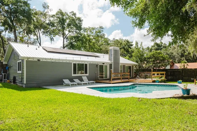 a view of a patio with table and chairs under an umbrella