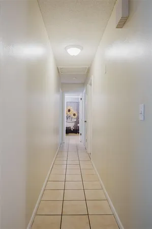 an empty room with wooden floor and a fireplace