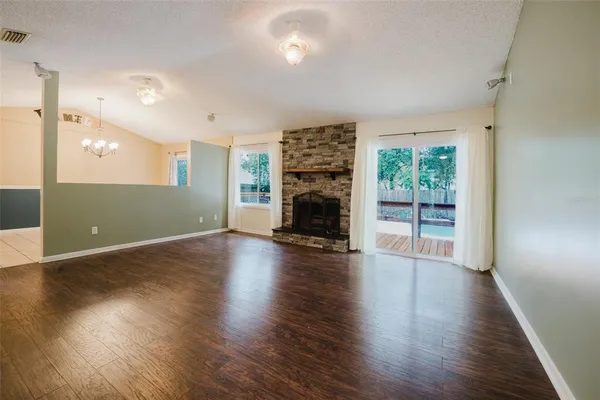a living room with a fireplace and a floor to ceiling window