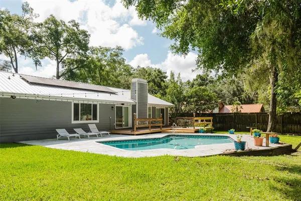 a view of a house with swimming pool and sitting area