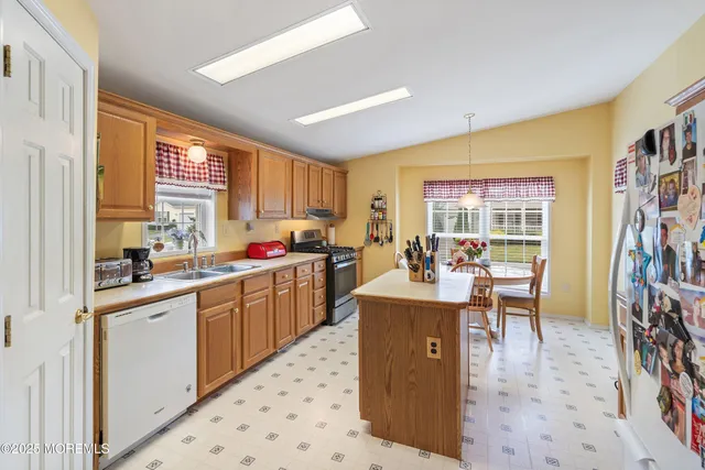 a dining room with furniture a chandelier and window