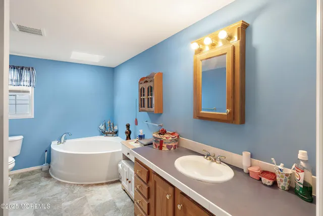 a view of walk in closet with clothes